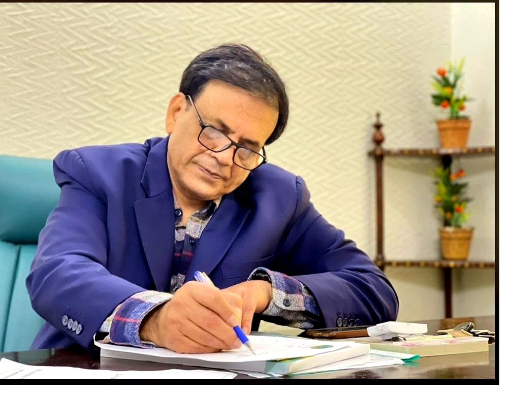 Dr. Aamir Mirza, Medical Director of Solace Rehab, writing notes in his consultation room